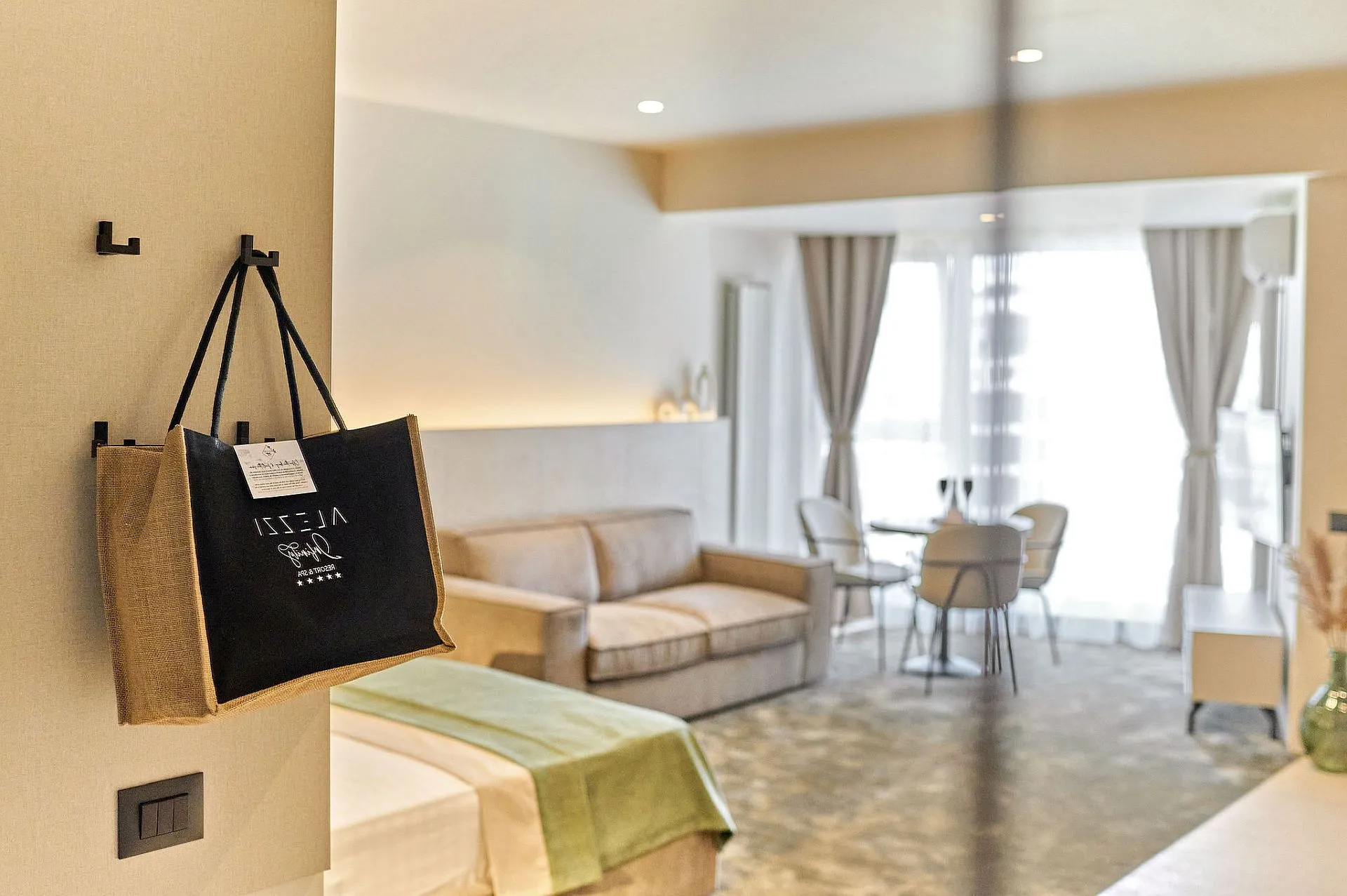 Queen Studio at Alezzi Infinity with double bed, sofa and dining area